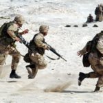 Soldiers running together with weapons